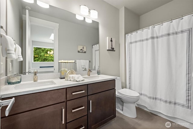 full bath with tile patterned flooring, a sink, double vanity, and toilet