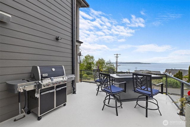 view of patio with outdoor dry bar, grilling area, and a balcony