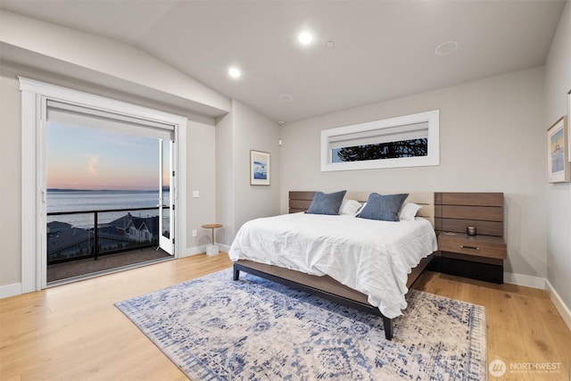 bedroom with baseboards, recessed lighting, wood finished floors, and access to exterior