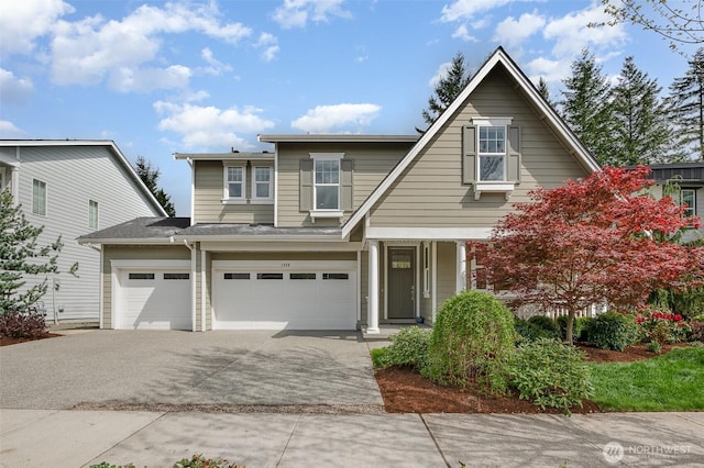 view of front of property featuring concrete driveway and a garage
