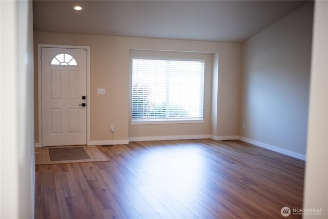 foyer entrance with wood finished floors, a healthy amount of sunlight, recessed lighting, and baseboards