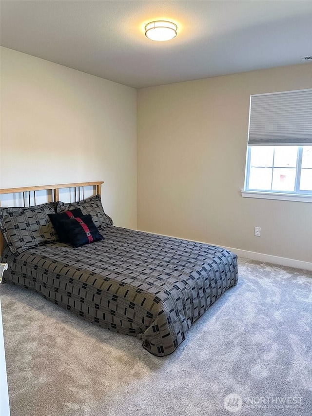 carpeted bedroom with baseboards