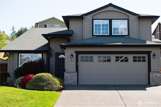 view of front of house with a garage, brick siding, and driveway