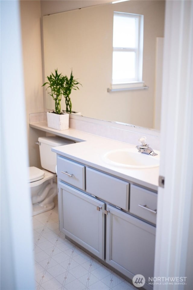 half bath featuring toilet and vanity