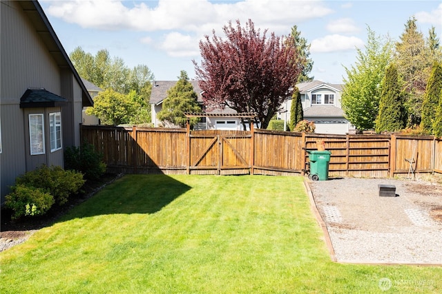 view of yard featuring a residential view and a fenced backyard