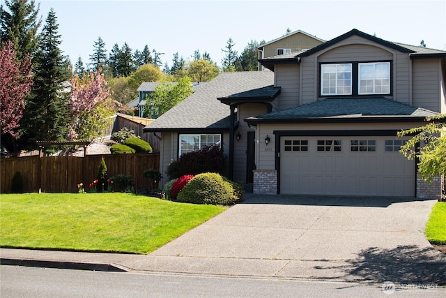 traditional-style house featuring brick siding, fence, driveway, roof with shingles, and a front yard