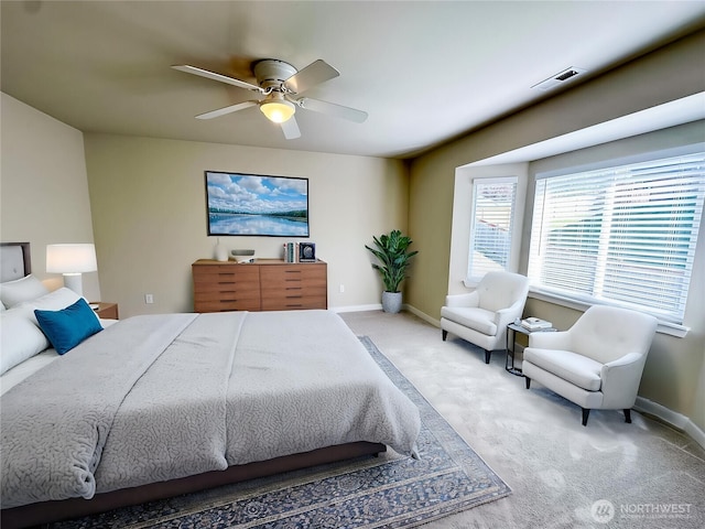 bedroom with baseboards, visible vents, ceiling fan, and carpet