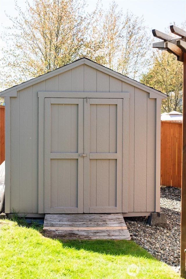 view of shed with fence
