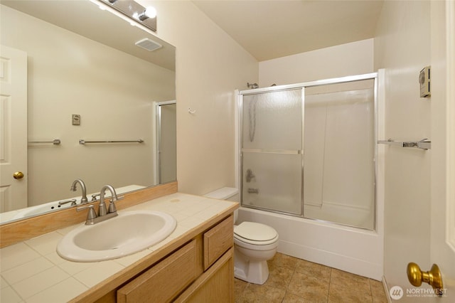 full bathroom featuring toilet, combined bath / shower with glass door, visible vents, tile patterned flooring, and vanity