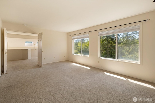 empty room with light colored carpet and baseboards