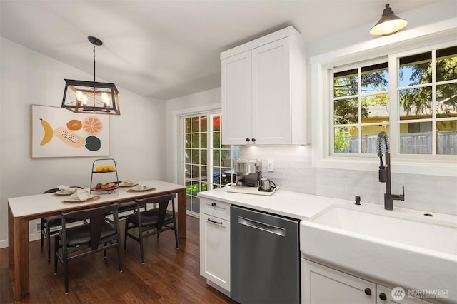kitchen with dark wood-style flooring, dishwasher, a sink, light countertops, and white cabinetry