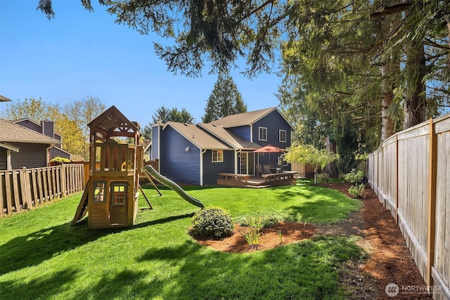 exterior space with a fenced backyard, a yard, and a deck