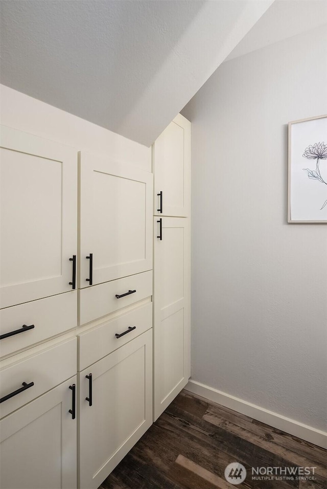 room details with baseboards and wood finished floors