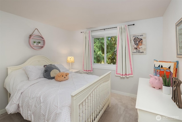 bedroom with light colored carpet and baseboards