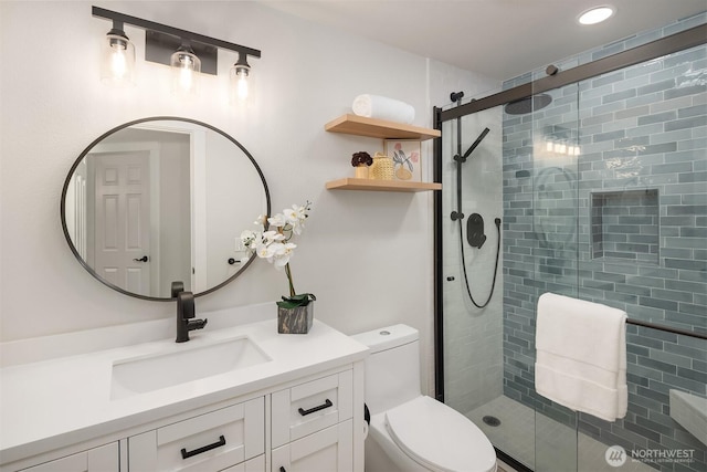 full bathroom featuring toilet, recessed lighting, a shower stall, and vanity