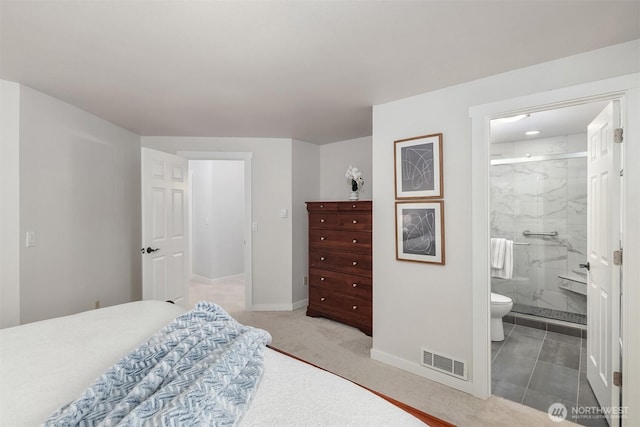 bedroom featuring baseboards, ensuite bathroom, and visible vents