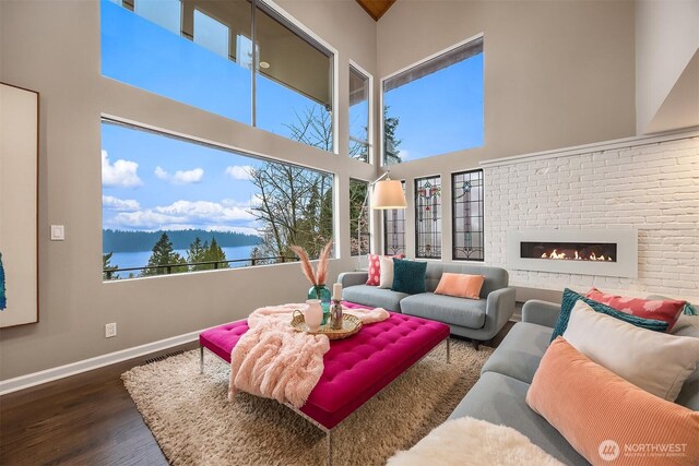 5340 W Mercer Way, Mercer Island, WA 98040 - living area featuring a high ceiling, wood finished floors, baseboards, plenty of natural light, and a fireplace