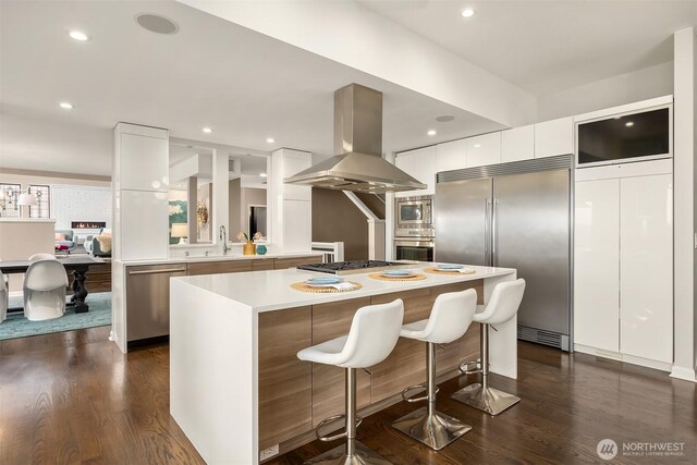 5340 W Mercer Way, Mercer Island, WA 98040 - kitchen with modern cabinets, built in appliances, island exhaust hood, white cabinets, and light countertops