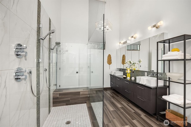 5340 W Mercer Way, Mercer Island, WA 98040 - bathroom with an enclosed shower, vanity, wood tiled floors, tasteful backsplash, and a towering ceiling