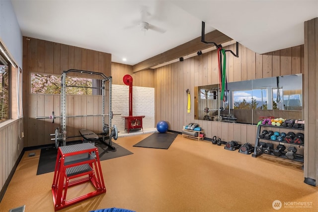 5340 W Mercer Way, Mercer Island, WA 98040 - workout room featuring a wood stove, wood walls, and a ceiling fan