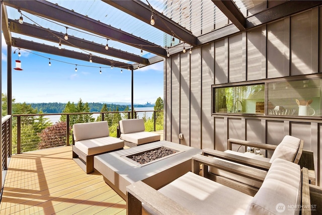 5340 W Mercer Way, Mercer Island, WA 98040 - wooden terrace featuring an outdoor fire pit, a water view, and a pergola