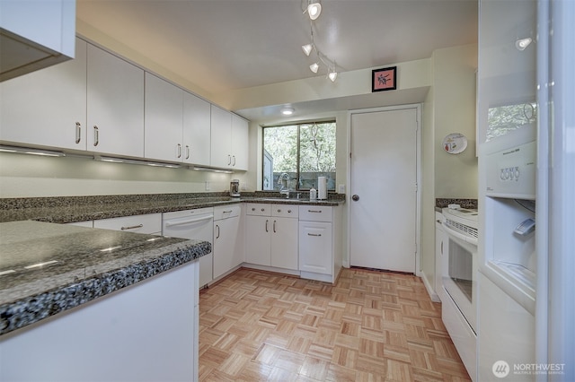3142 Sahali Dr NE, Bremerton, WA 98310 - kitchen with dark countertops, a sink, white cabinetry, and white appliances