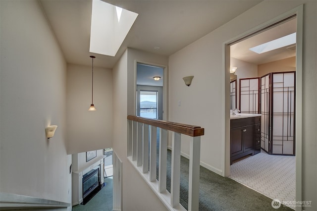 3142 Sahali Dr NE, Bremerton, WA 98310 - corridor with baseboards, carpet floors, a sink, and a skylight