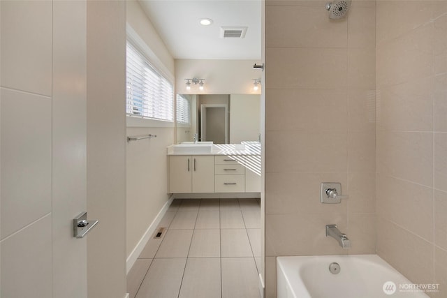 full bathroom featuring vanity, tile patterned floors, baseboards, bathing tub / shower combination, and visible vents