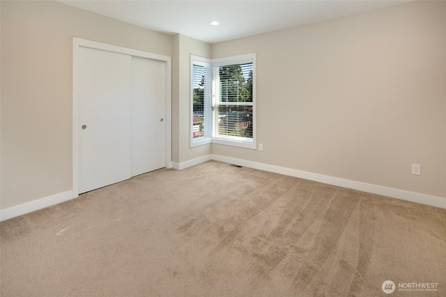 unfurnished bedroom featuring carpet floors and baseboards