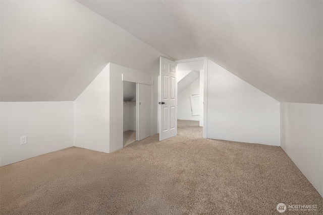 bonus room featuring lofted ceiling and carpet