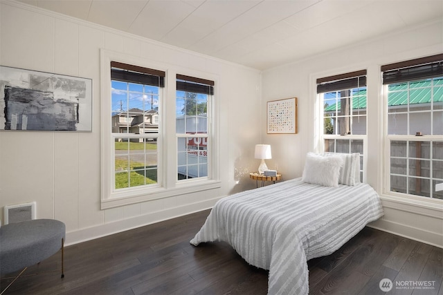 bedroom with ornamental molding, visible vents, multiple windows, and dark wood-type flooring