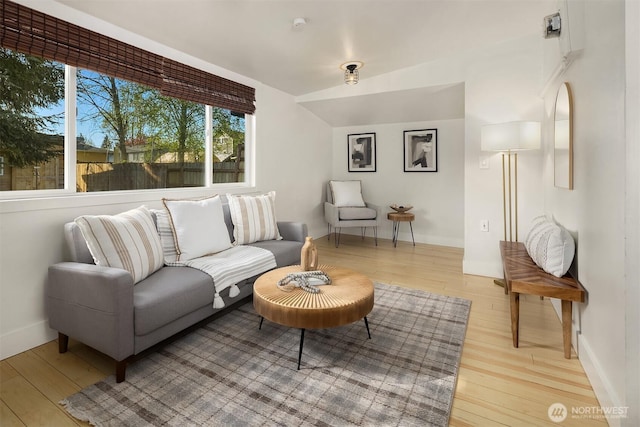 living area with baseboards and light wood-type flooring