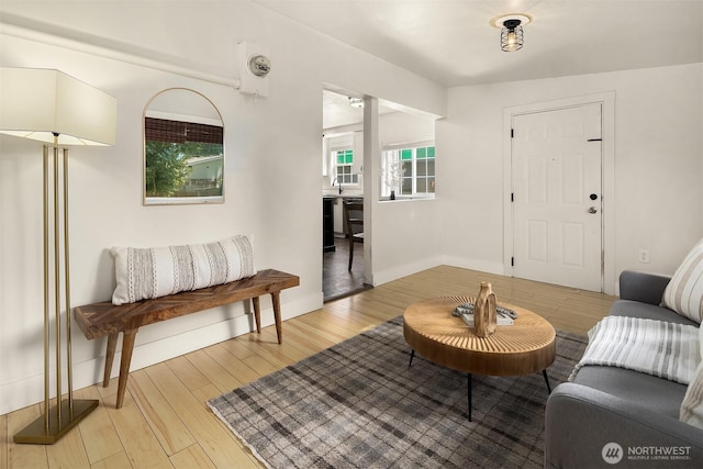 living area featuring wood finished floors and baseboards