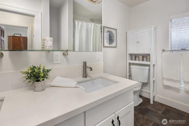 bathroom with toilet, vanity, and a shower with shower curtain