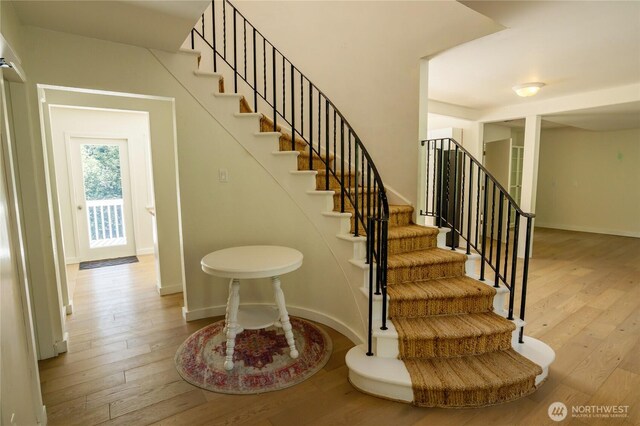 stairs with baseboards and wood-type flooring