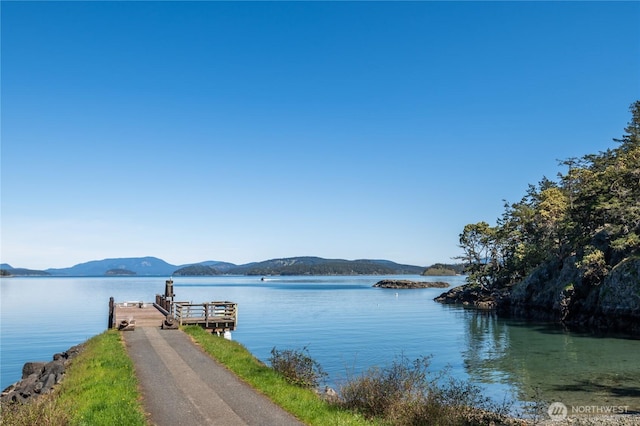 view of water feature with a mountain view and a boat dock