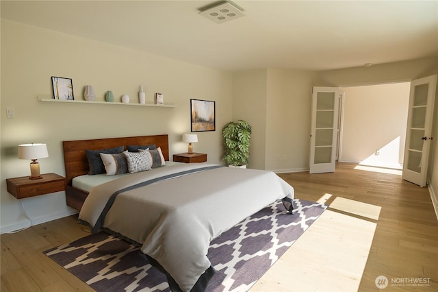 bedroom featuring baseboards and hardwood / wood-style flooring