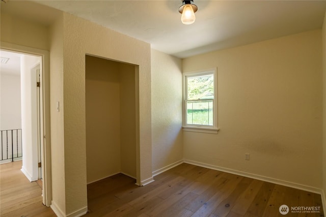unfurnished bedroom featuring baseboards and light wood-style flooring