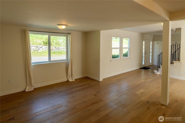 interior space featuring baseboards, stairway, and wood-type flooring