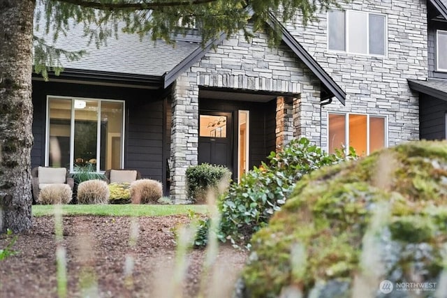 entrance to property featuring stone siding