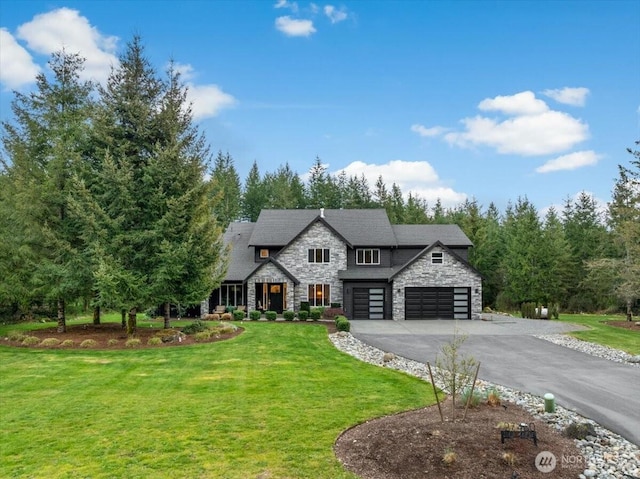 view of front of house with a garage, driveway, stone siding, and a front yard