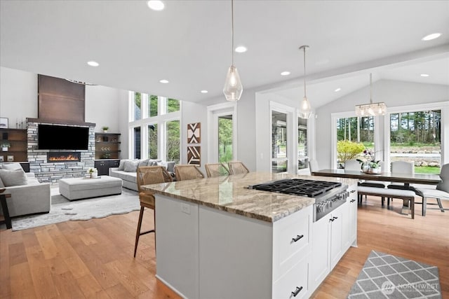 kitchen featuring stainless steel gas stovetop, plenty of natural light, and light wood-type flooring