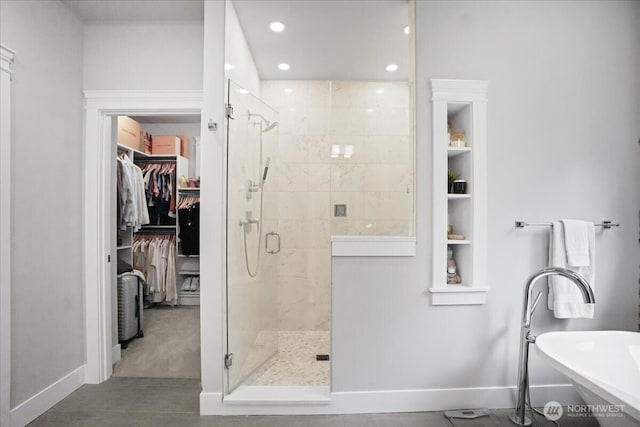 full bathroom with a spacious closet, baseboards, recessed lighting, and a stall shower
