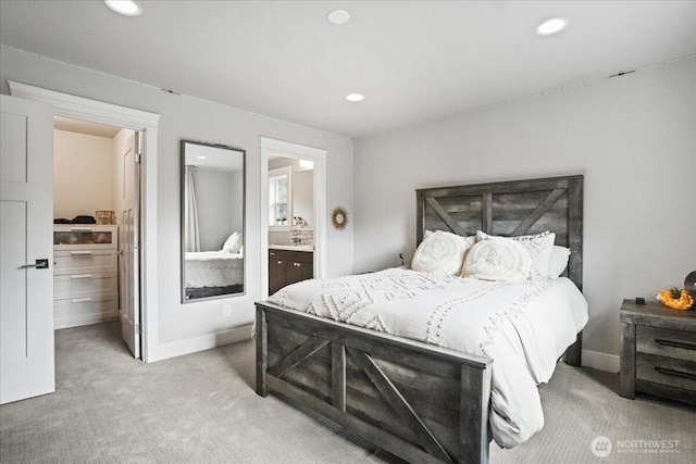 bedroom featuring connected bathroom, baseboards, recessed lighting, and carpet