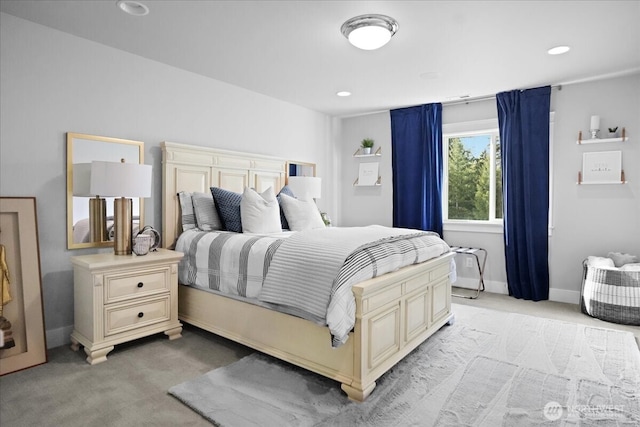 bedroom with recessed lighting, baseboards, and light carpet