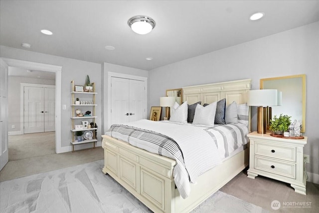 bedroom featuring light colored carpet, baseboards, recessed lighting, and a closet