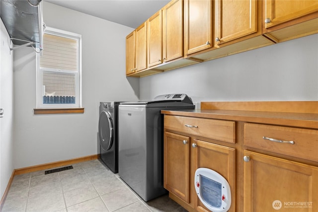 1509 Seahawk Dr, Ferndale, WA 98248 - laundry area with visible vents, baseboards, separate washer and dryer, cabinet space, and light tile patterned floors