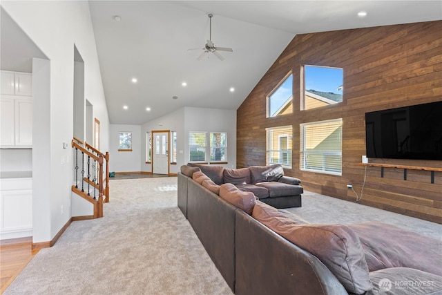 1509 Seahawk Dr, Ferndale, WA 98248 - living room with high vaulted ceiling, wood walls, a ceiling fan, recessed lighting, and stairway