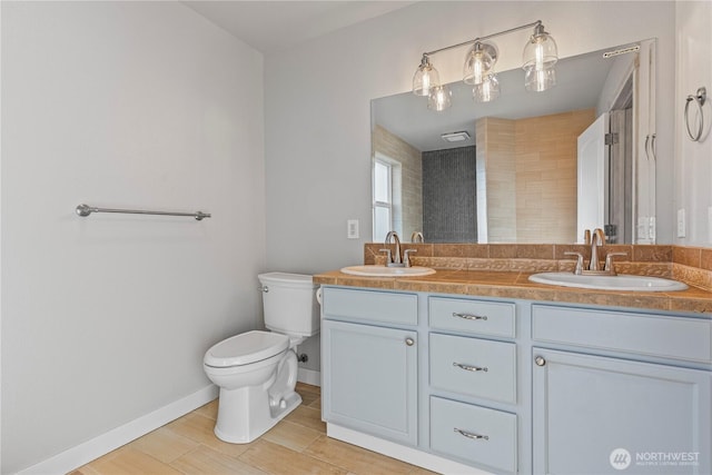 1509 Seahawk Dr, Ferndale, WA 98248 - bathroom with double vanity, toilet, baseboards, and a sink