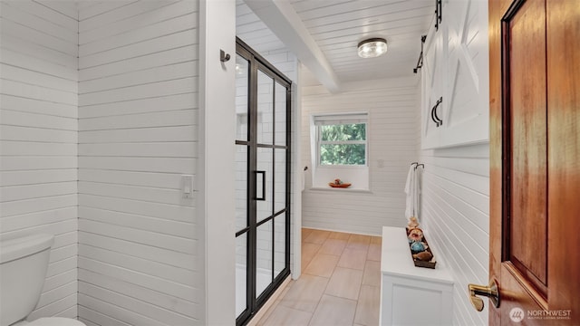 interior space featuring beam ceiling and light tile patterned flooring
